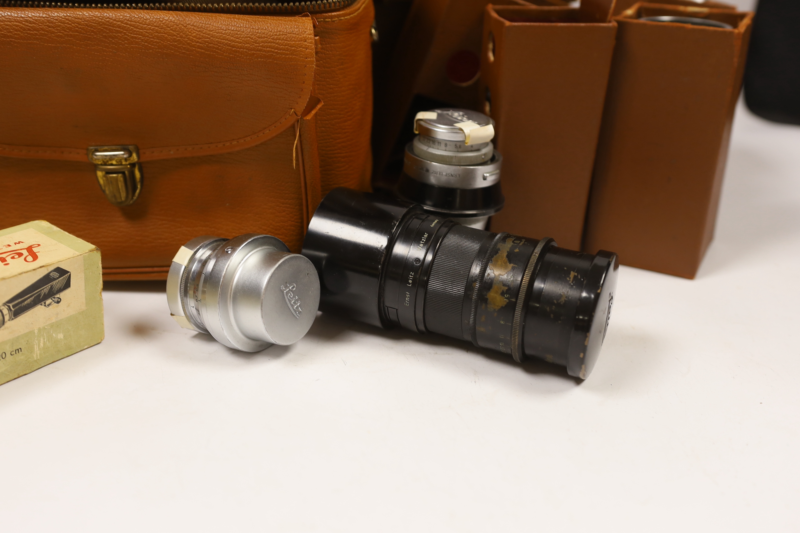 Leica accessories including; a Leitz Visoflex I and Visoflex II, a Summarit f-5cm 1:1.5 lens, an Elmar f=9cm 1:4lens, a Super Angulon 1:4/21 lens, a Range Finder, a Leitz Telyt f=20cm 1:4.5 lens, a Leitz Telyt SFT00 view